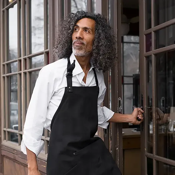 Happy restaurant employee enjoying his great benefits