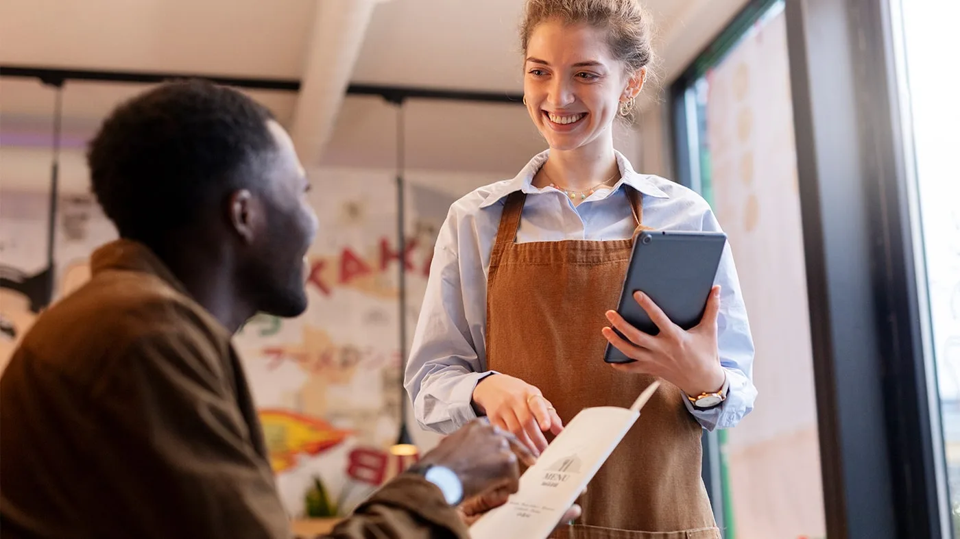 Staff talking to restaurant guests to increase customer satisfaction