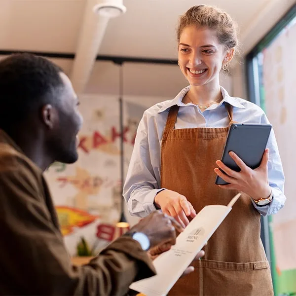 Staff talking to restaurant guests to improve customer satisfaction