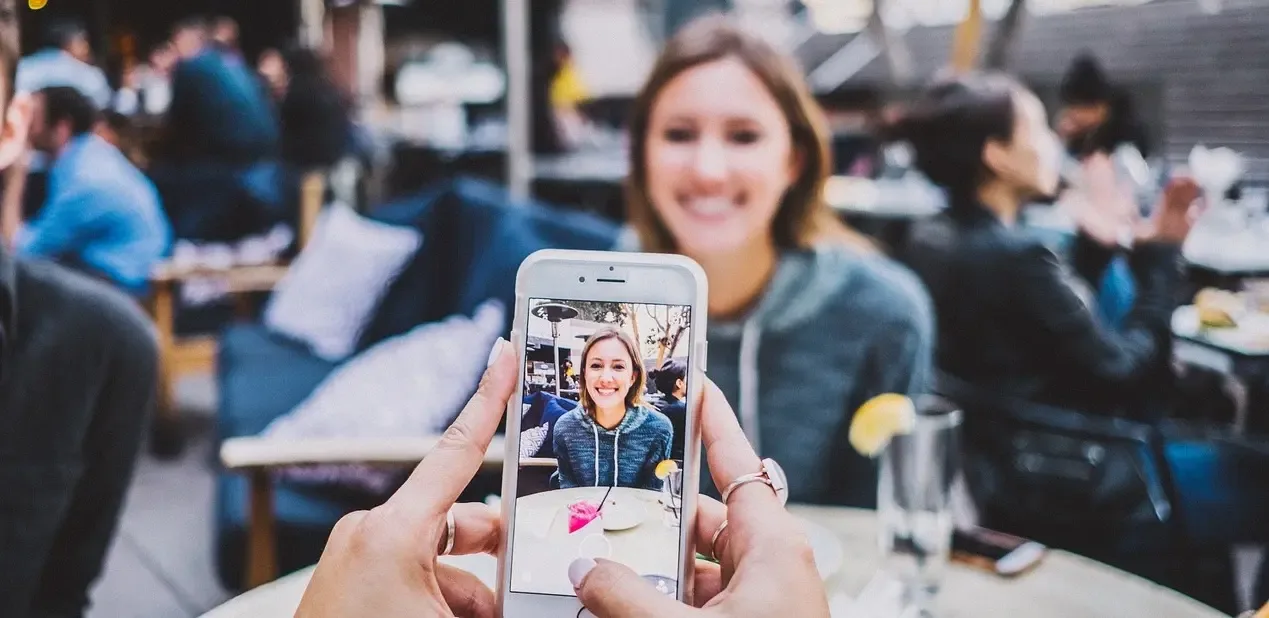 Woman taking a picture for her social media account in a Restaurant